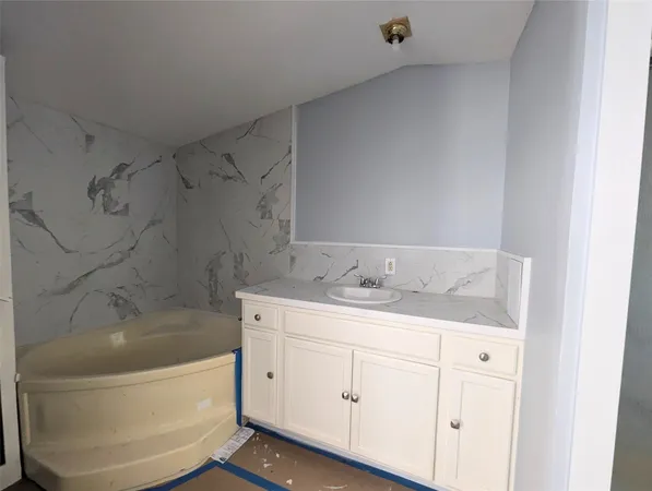 a bathroom with a sink and vanity