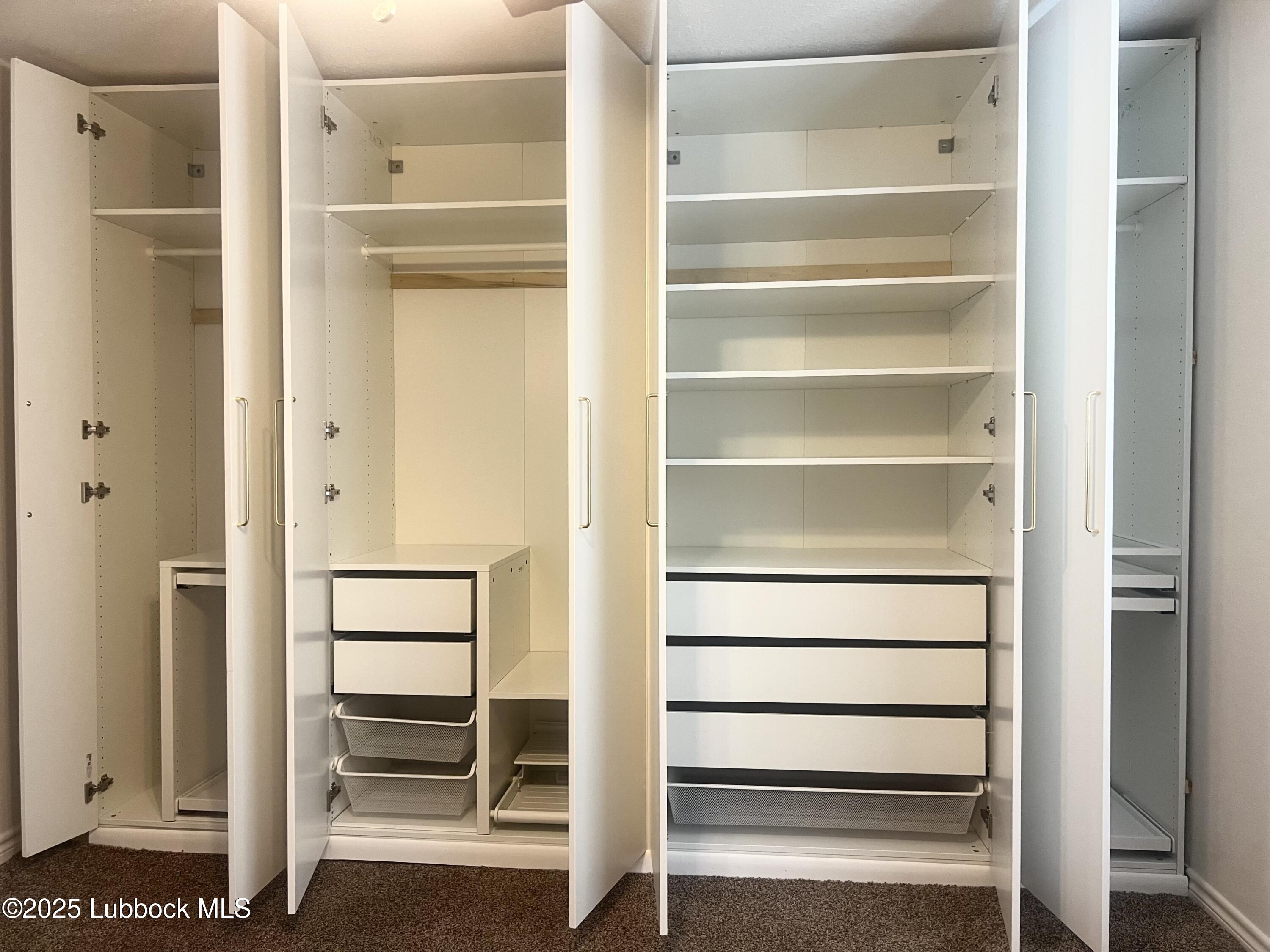 2427 26th Street Lubbock, TX 79411 - Photo 17 of 28 a view of walk in closet with empty racks