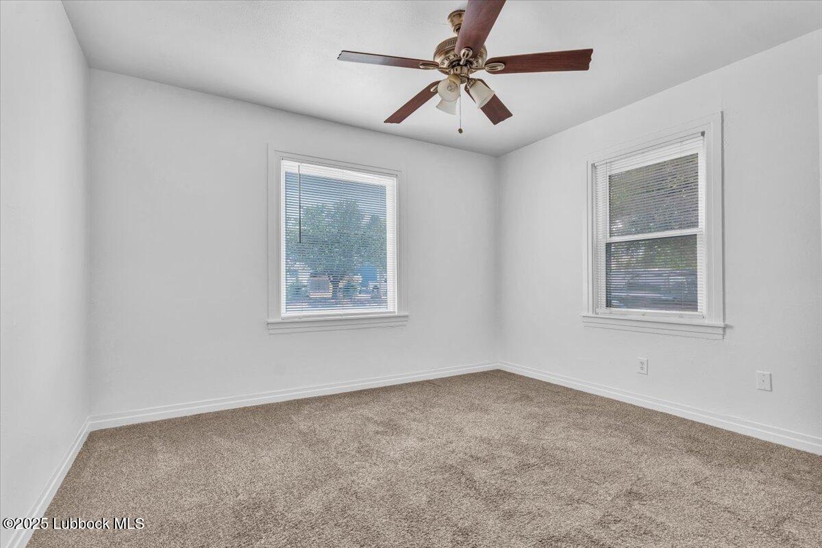 2427 26th Street Lubbock, TX 79411 - Photo 22 of 28 an empty room with windows and fan