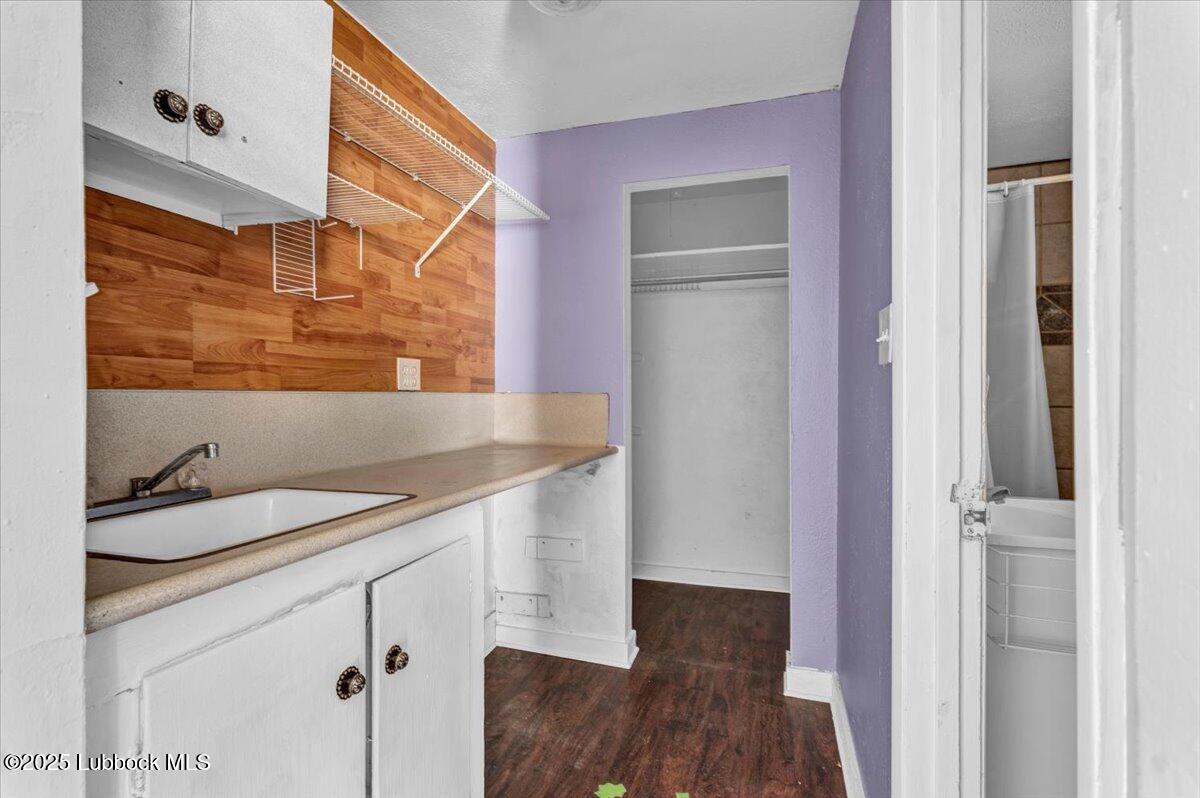 2427 26th Street Lubbock, TX 79411 - Photo 23 of 28 a bathroom with a sink and a mirror