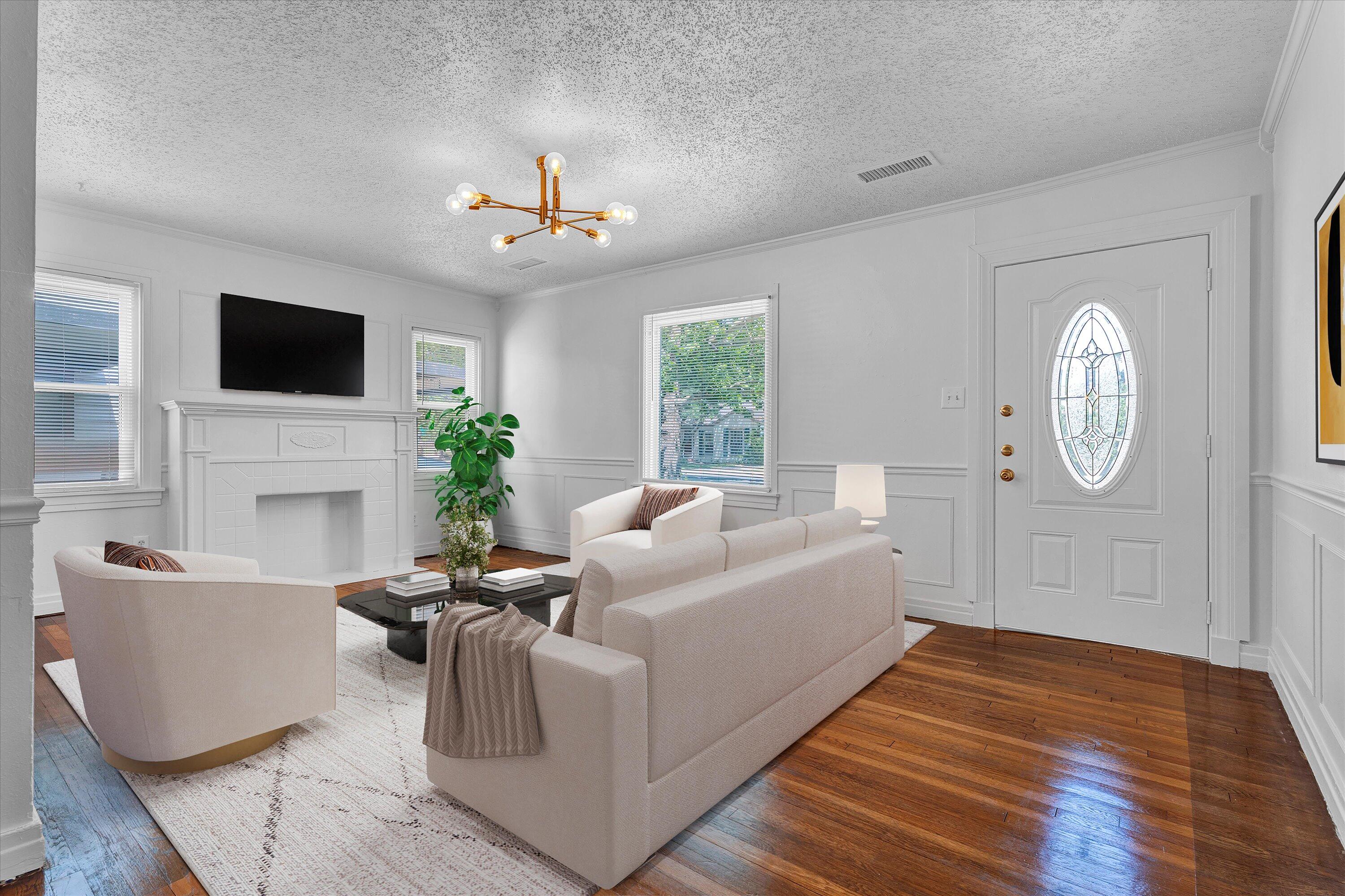 2427 26th Street Lubbock, TX 79411 - Photo 4 of 28 a living room with fireplace furniture and a flat screen tv