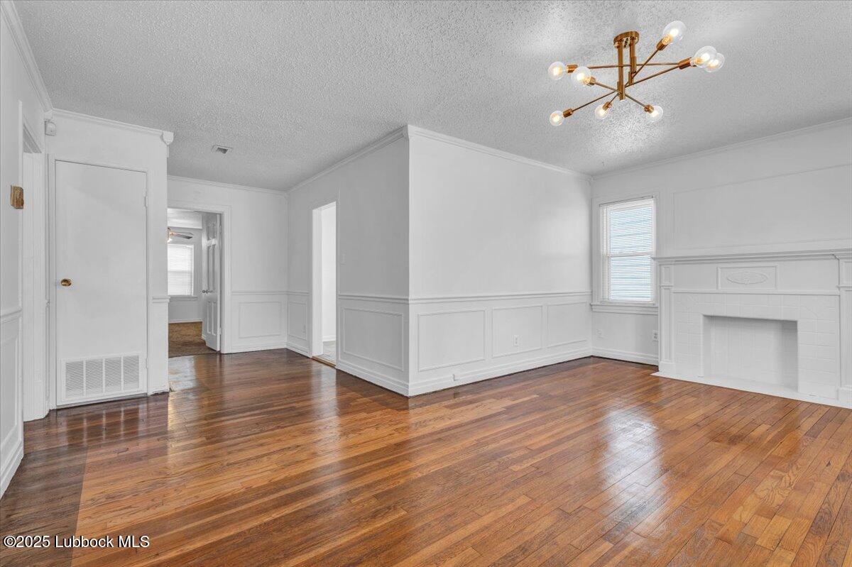 2427 26th Street Lubbock, TX 79411 - Photo 8 of 28 a view of an empty room with window and wooden floor
