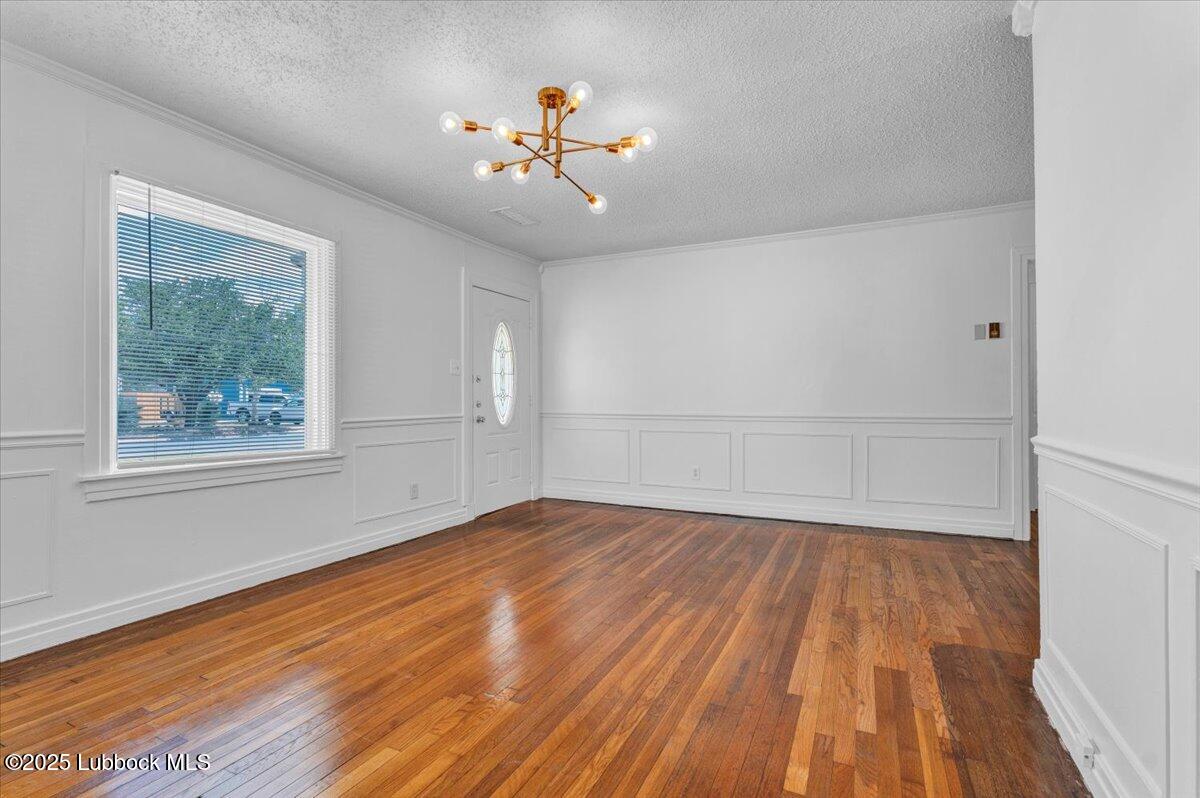 2427 26th Street Lubbock, TX 79411 - Photo 9 of 28 a view of empty room with wooden floor and fan