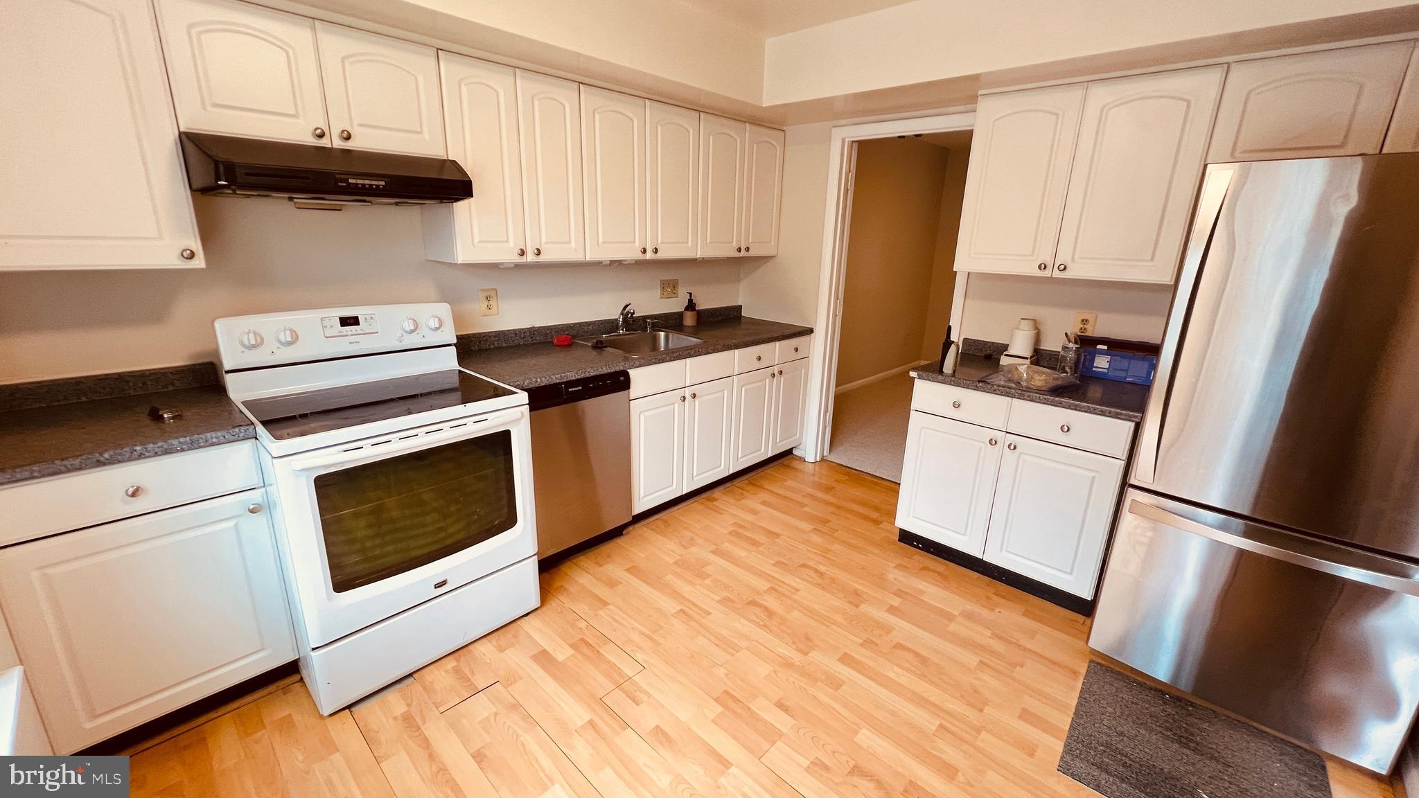 7853 Muirfield Court Potomac, MD 20854 - Photo 2 of 25 a kitchen with stainless steel appliances a stove a microwave and a refrigerator