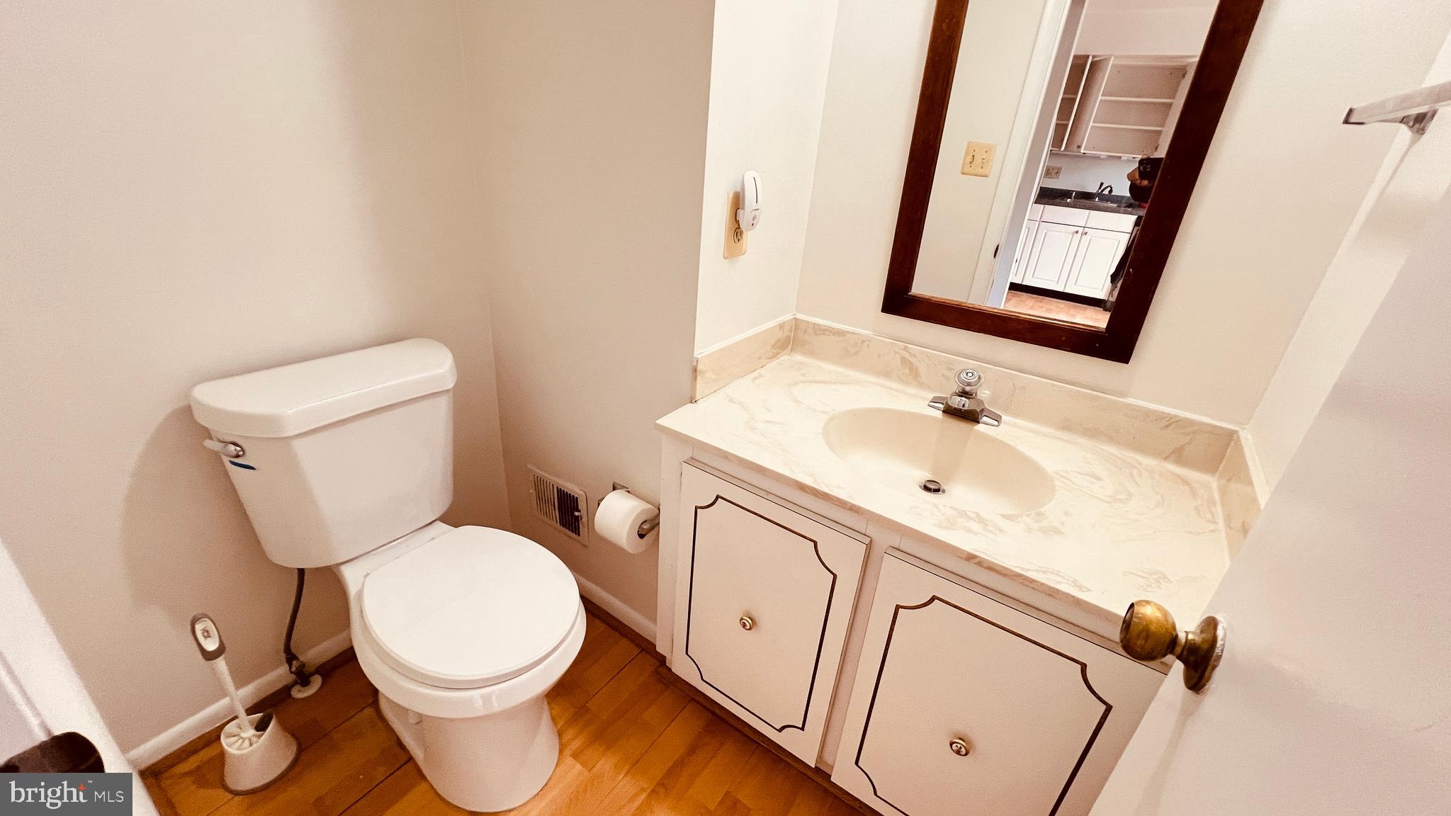 7853 Muirfield Court Potomac, MD 20854 - Photo 4 of 25 a white toilet sitting next to a bathroom sink