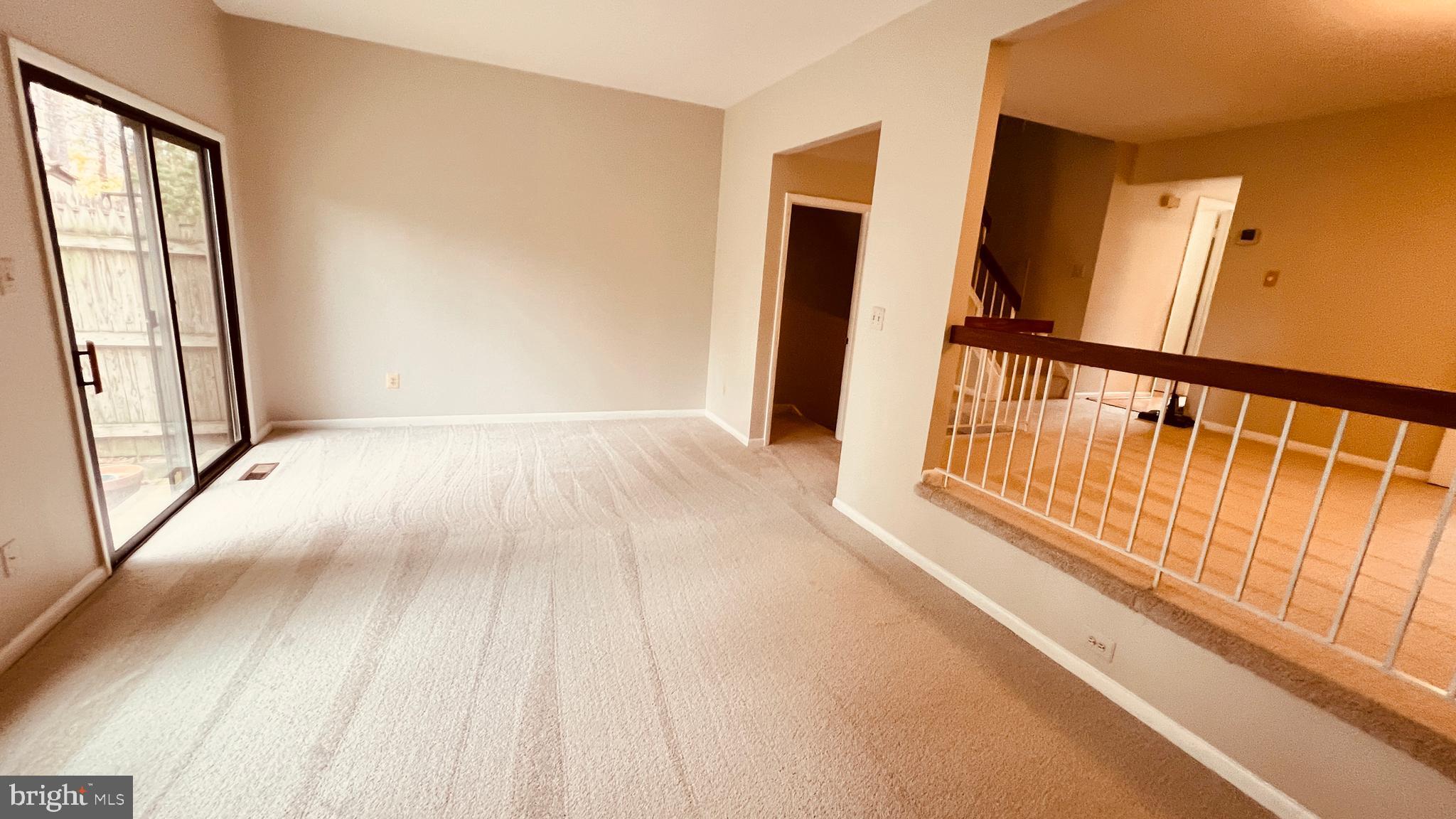 7853 Muirfield Court Potomac, MD 20854 - Photo 8 of 25 a view of a hallway with wooden floor and staircase