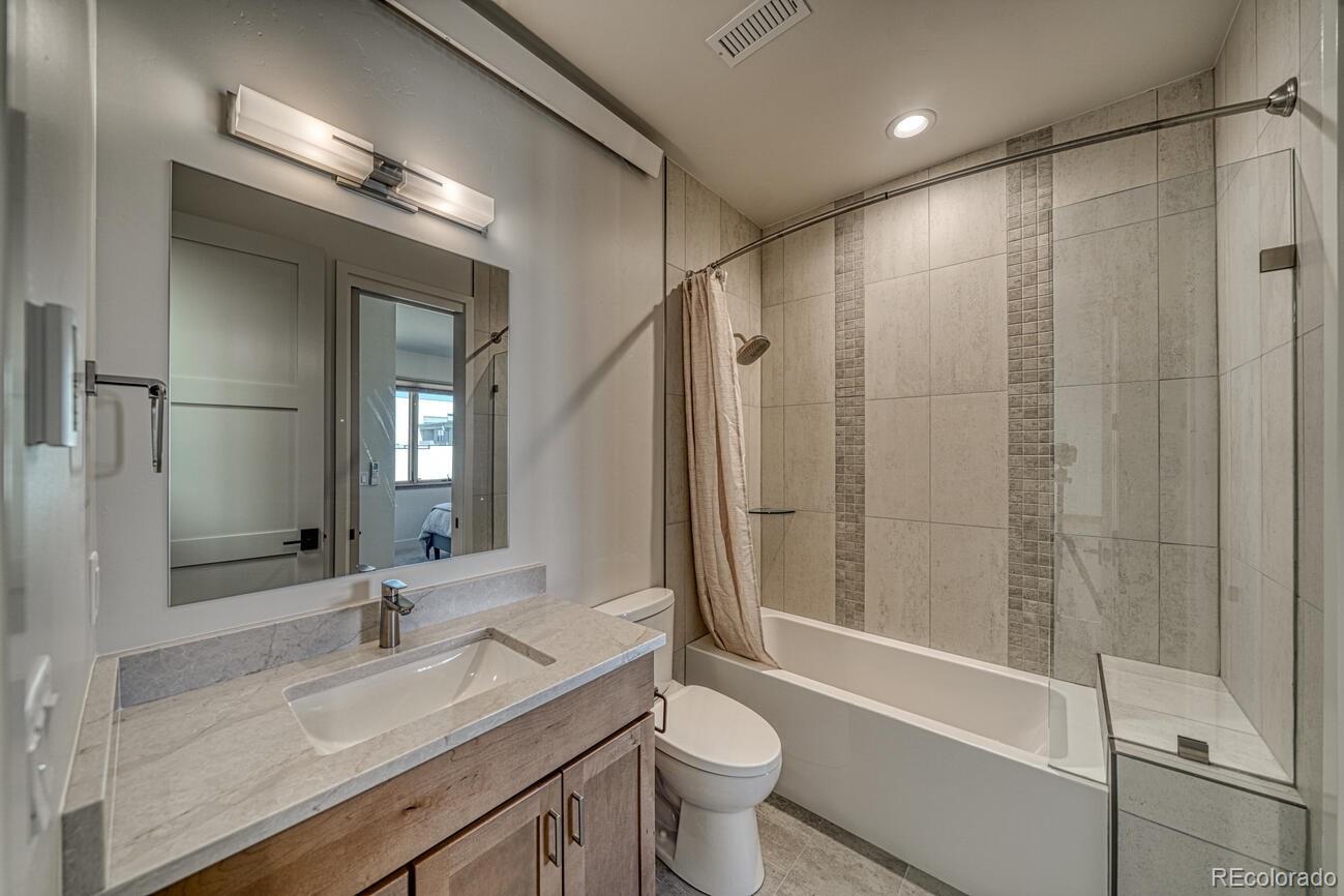 205 Two Rivers Road, Unit G Salida, CO 81201 - Photo 16 of 22 a bathroom with a double vanity sink toilet mirror and bathtub