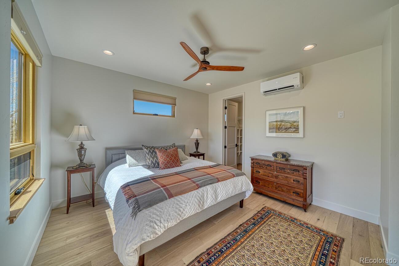205 Two Rivers Road, Unit G Salida, CO 81201 - Photo 17 of 22 a bedroom with a bed and a lamp