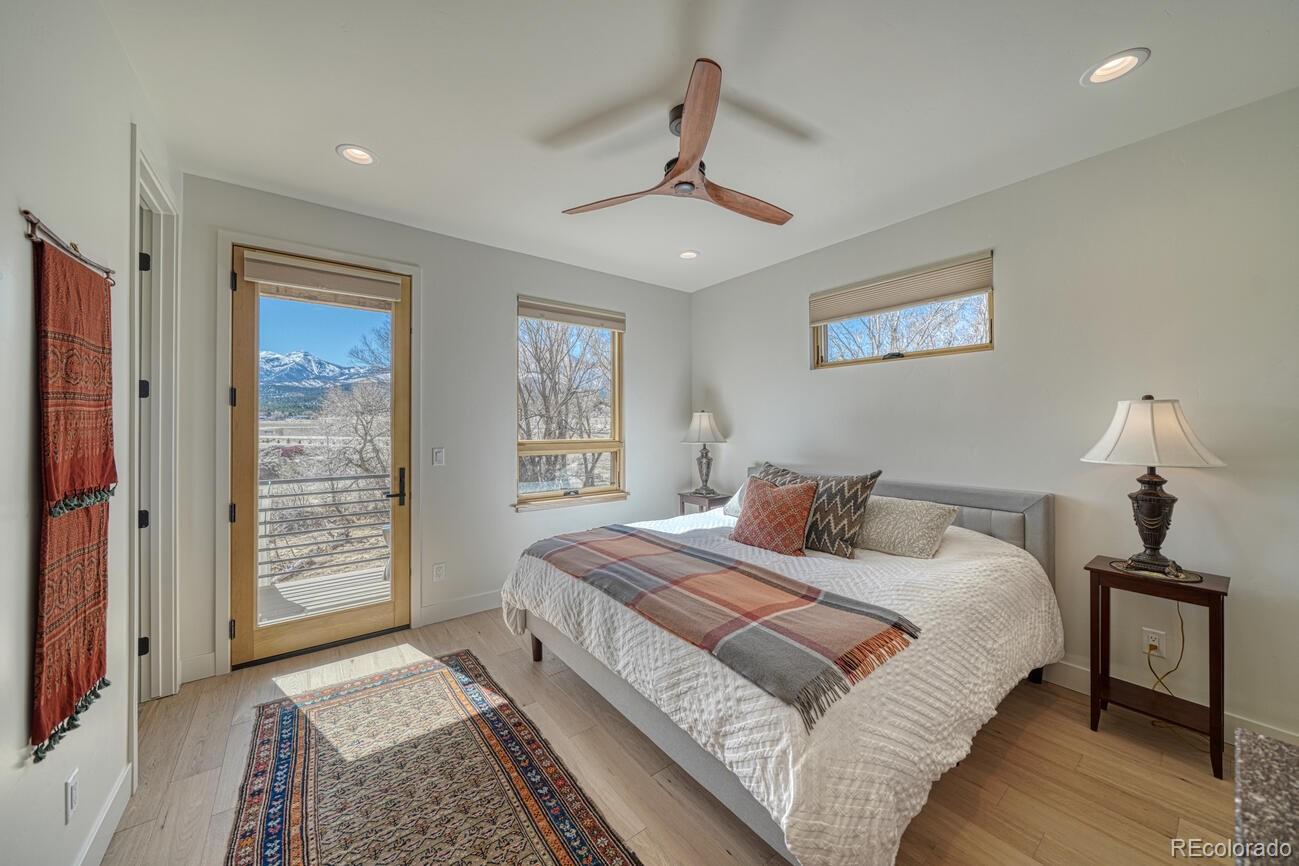 205 Two Rivers Road, Unit G Salida, CO 81201 - Photo 20 of 22 a bedroom with a large bed and a window