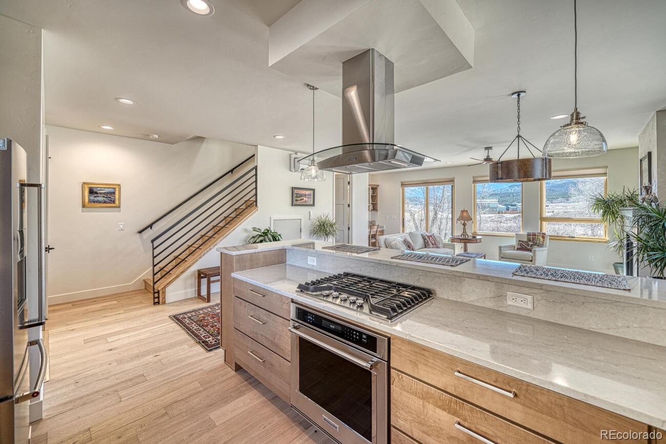 205 Two Rivers Road, Unit G Salida, CO 81201 - Photo 6 of 22 a kitchen with a stove and a wooden floor