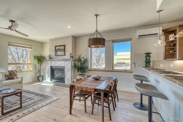 a dining room with furniture a chandelier and wooden floor