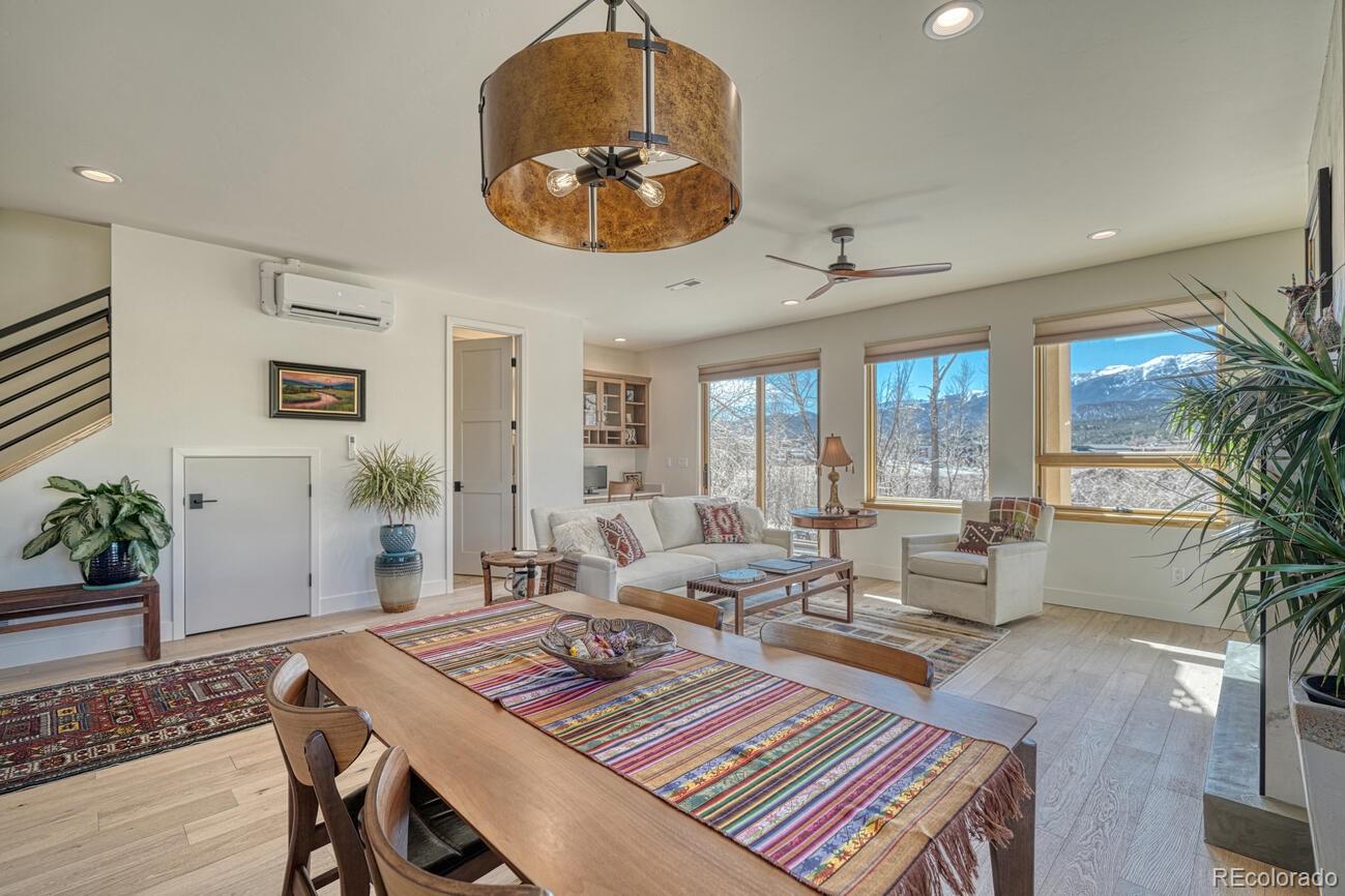205 Two Rivers Road, Unit G Salida, CO 81201 - Photo 8 of 22 a living room with furniture and a chandelier