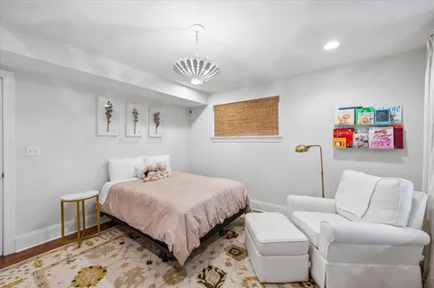 a bedroom with a bed and a chandelier
