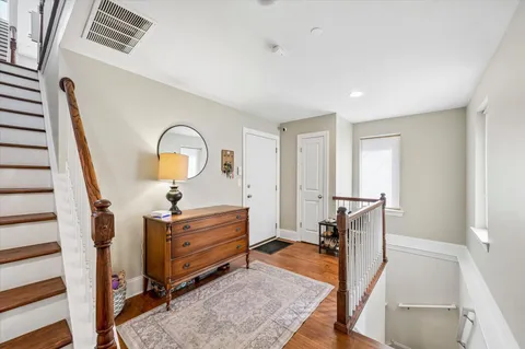 a view of living room with furniture and wooden floor