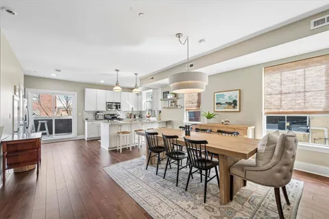 a view of a dining room with furniture window and wooden floor
