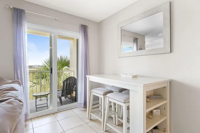 a view of a room that has a bed and a window in it