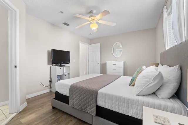 a bedroom with a bed and a flat screen tv