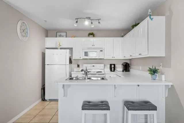a kitchen with stainless steel appliances granite countertop a refrigerator sink and cabinets