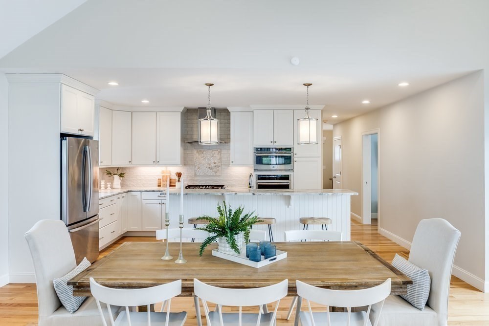 56 Cottage Lane Mashpee, MA 02649 - Photo 11 of 42 a kitchen with refrigerator and chairs