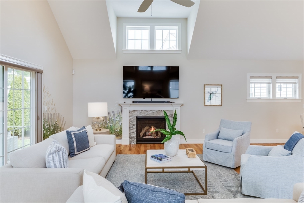56 Cottage Lane Mashpee, MA 02649 - Photo 15 of 42 a living room with furniture a fireplace and a flat screen tv