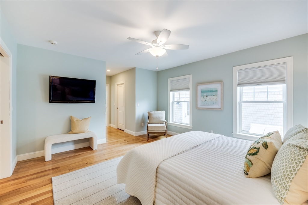 56 Cottage Lane Mashpee, MA 02649 - Photo 22 of 42 a bedroom with a bed a tv and wooden floor
