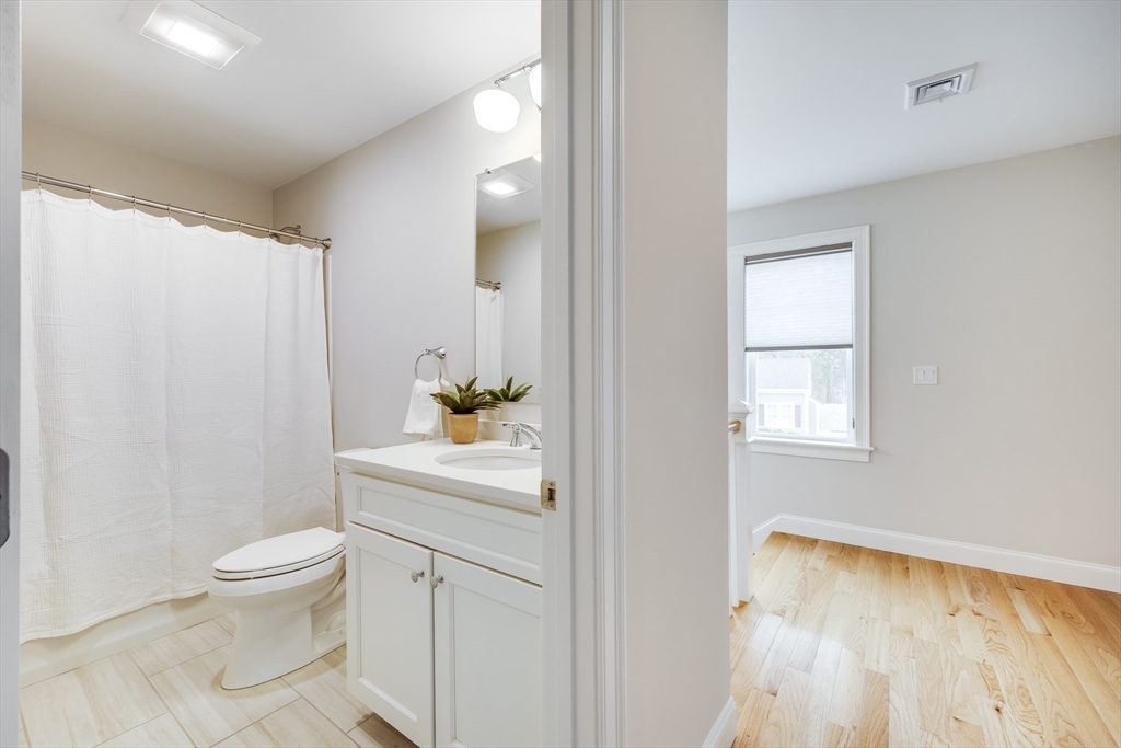 56 Cottage Lane Mashpee, MA 02649 - Photo 26 of 42 a bathroom with a sink a toilet and a mirror