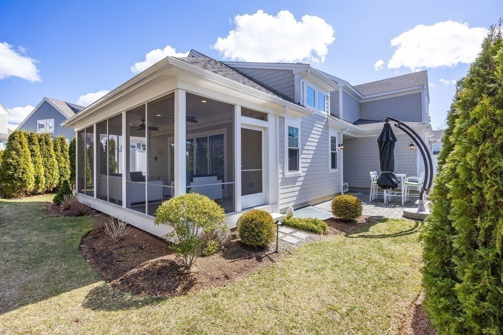 56 Cottage Lane Mashpee, MA 02649 - Photo 32 of 42 a view of a brick house with large windows