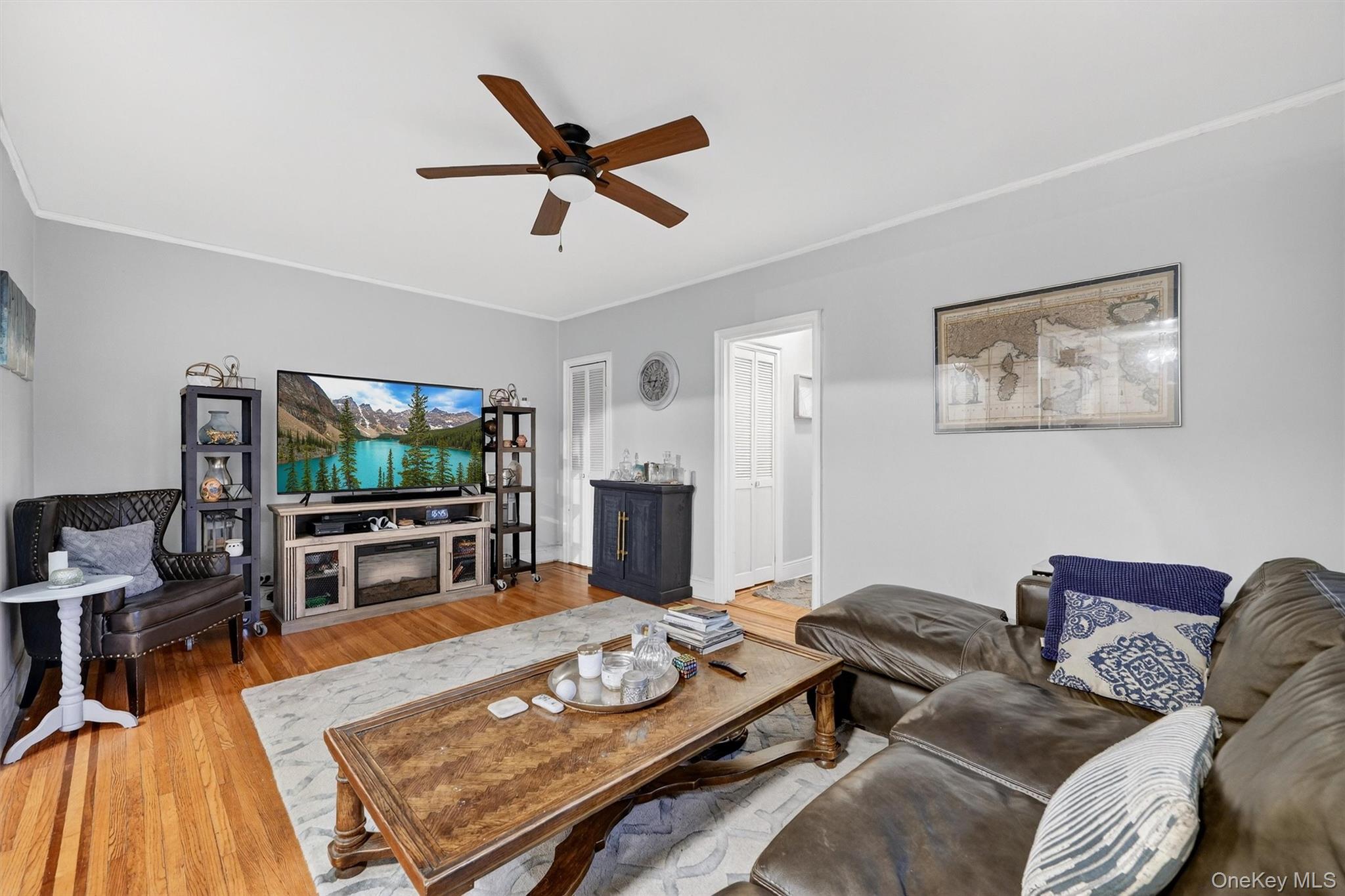 475 Bronx River Road, Unit 2D Yonkers, NY 10704 - Photo 11 of 27 a living room with furniture and a flat screen tv