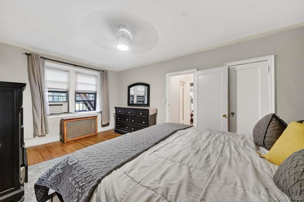 475 Bronx River Road, Unit 2D Yonkers, NY 10704 - Photo 22 of 27 a bedroom with a bed and a large window with the outer view