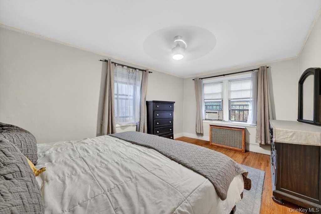 475 Bronx River Road, Unit 2D Yonkers, NY 10704 - Photo 23 of 27 a bedroom with a large bed and a flat tv screen