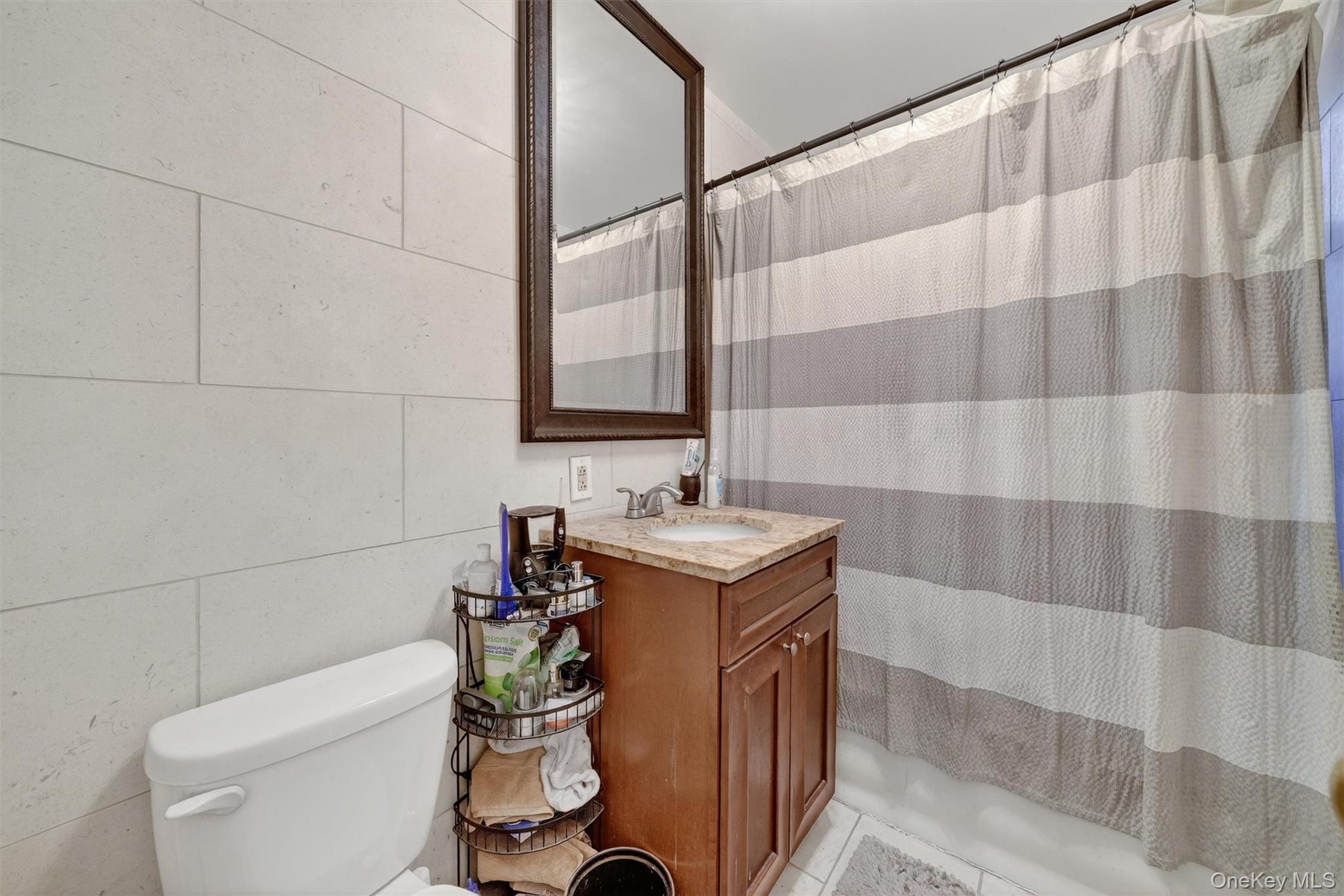 475 Bronx River Road, Unit 2D Yonkers, NY 10704 - Photo 24 of 27 a bathroom with a sink a toilet and shower