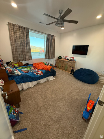3550 North River Ln Road East Panguitch, UT 84759 - Photo 6 of 25 Spacious room featuring neutral carpeting, a large window, and a ceiling fan with integrated lighting
