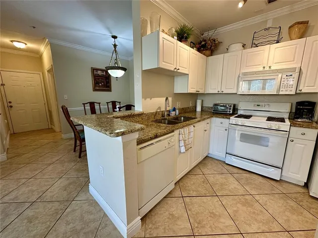 a kitchen with a stove sink and cabinets