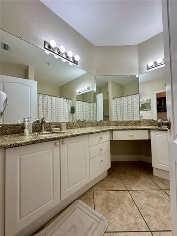 a large bathroom with a large tub and sink