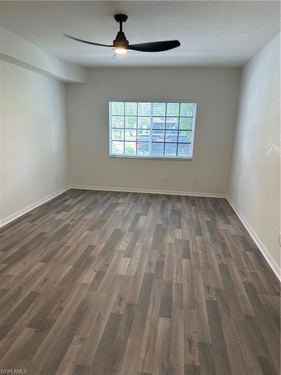 27103 Matheson Avenue, Unit 103 Bonita Springs, FL 34135 - Photo 11 of 29 Spare room featuring a textured ceiling, ceiling fan, and dark hardwood / wood-style floors