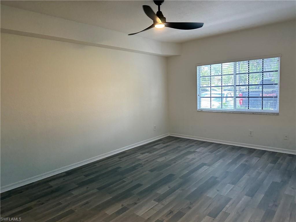 27103 Matheson Avenue, Unit 103 Bonita Springs, FL 34135 - Photo 12 of 29 Unfurnished room featuring dark wood-type flooring and ceiling fan
