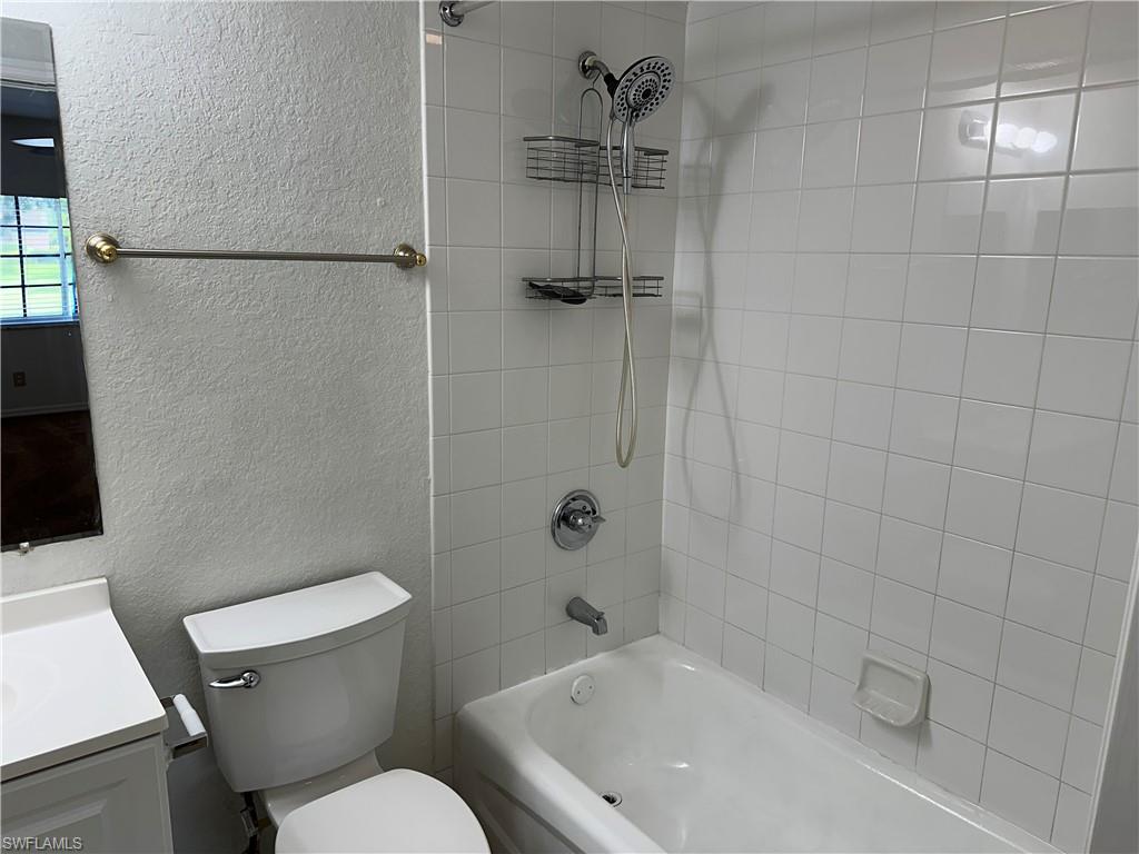 27103 Matheson Avenue, Unit 103 Bonita Springs, FL 34135 - Photo 20 of 29 Full bathroom with tiled shower / bath combo, vanity, and toilet