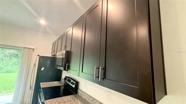 a view of a livingroom with wooden floor and a sink