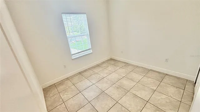 an empty room with white walls and tiles