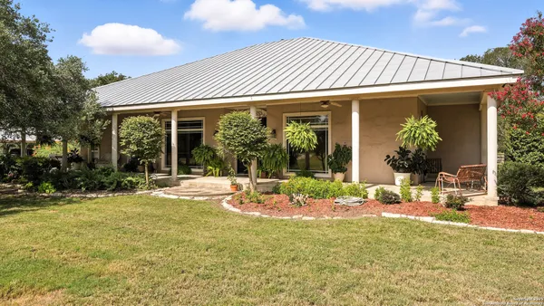 a front view of a house with a garden and patio
