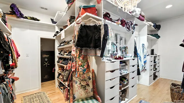 a bedroom with a bed chandelier and a window