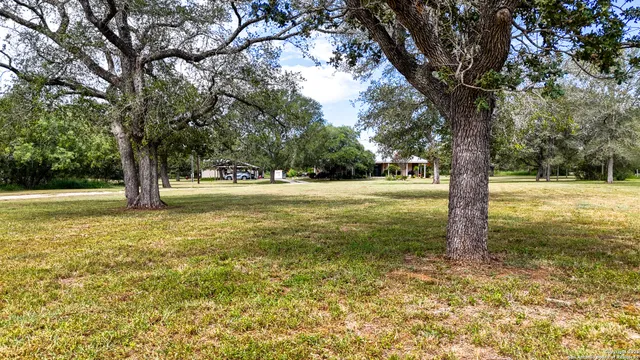 an aerial view of a residential houses covered with trees