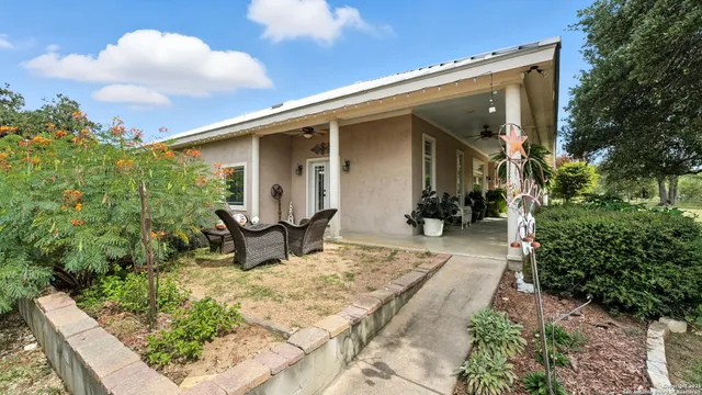 a backyard of a house with yard barbeque oven and outdoor seating