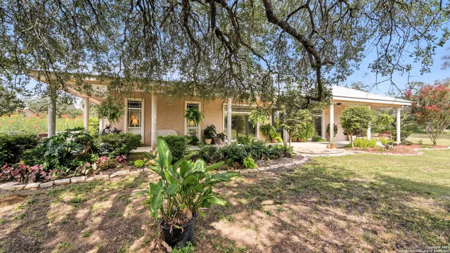 a front view of a house with a yard and fountain