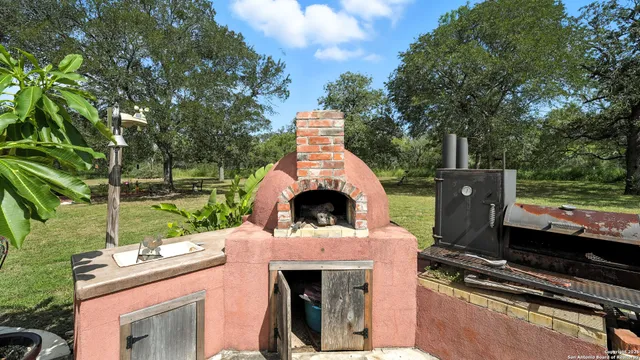 a view of a house with backyard sitting area and porch