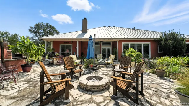 a view of a swimming pool with a bench in patio
