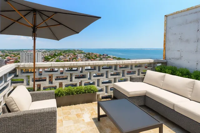 a terrace with outdoor seating and city view