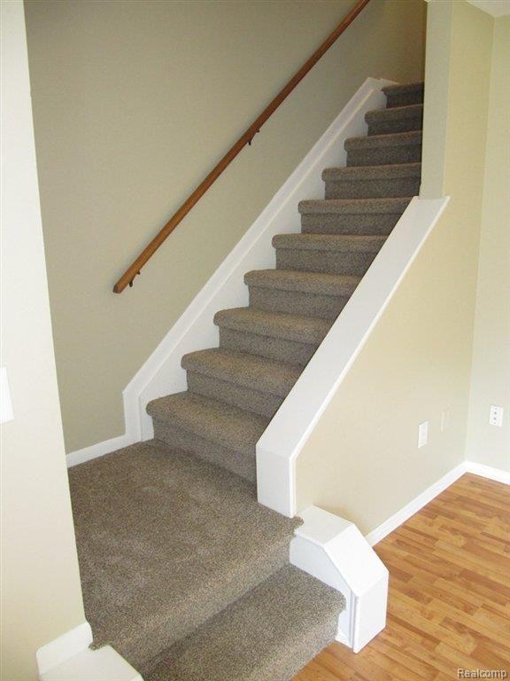 1141 Tienken Court, Unit 21 Rochester, MI 48306 - Photo 13 of 18 Stairway with new carpet