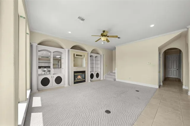 a view of a livingroom with a ceiling fan and window