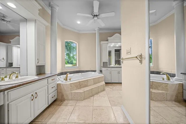 a large spacious bathroom with a tub shower and sink